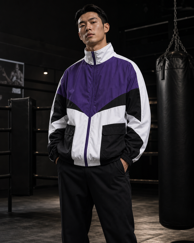 Man wearing purple Apex Utility Training Jacket in a boxing gym