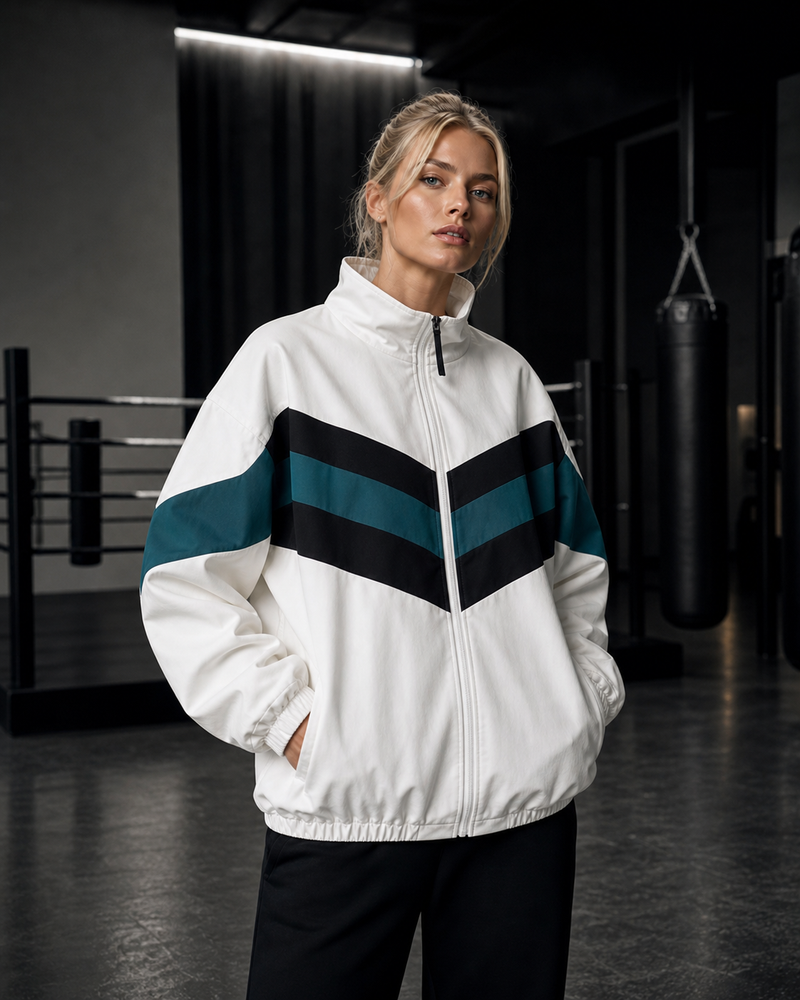 Woman wearing white Chevron Motion Training Windbreaker in a boxing gym
