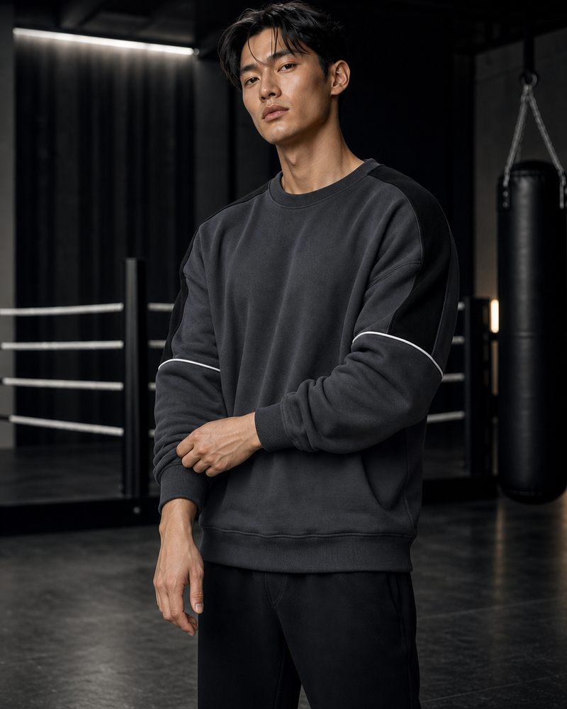 Asian ATHENIS model wearing the grey contrast training sweatshirt in a boxing gym